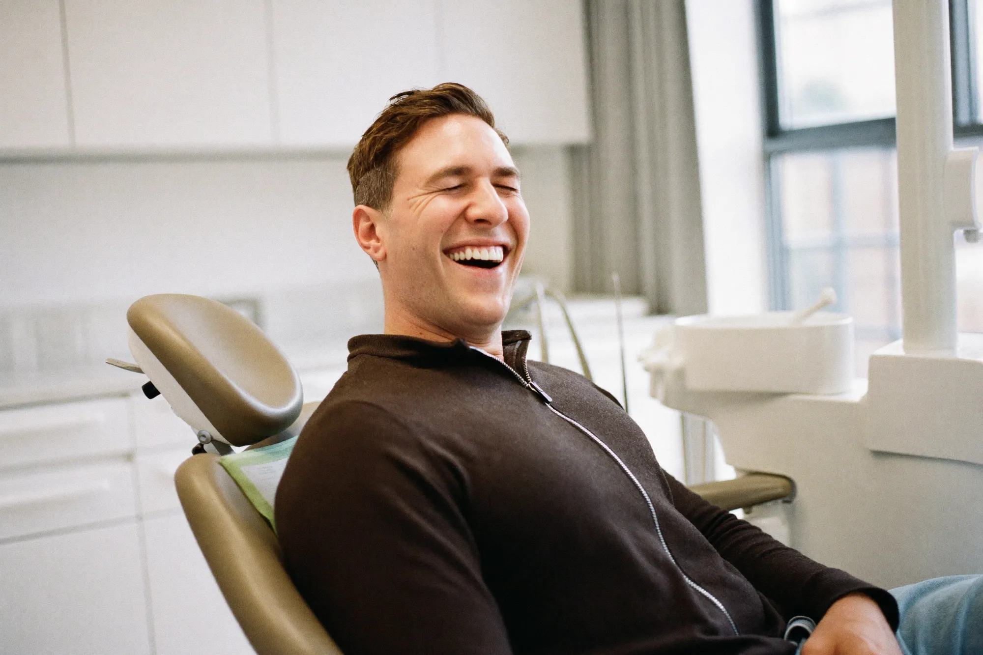 A patient looking relaxed and happy in the dental chair